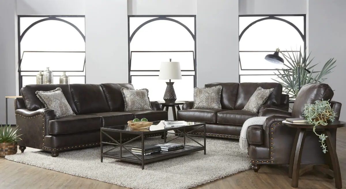 Ridgeline Brownie 2 Piece Living Room Set, featuring a plush sofa and loveseat upholstered in dark brown fabric with nailhead trim and ornately carved wooden feet.