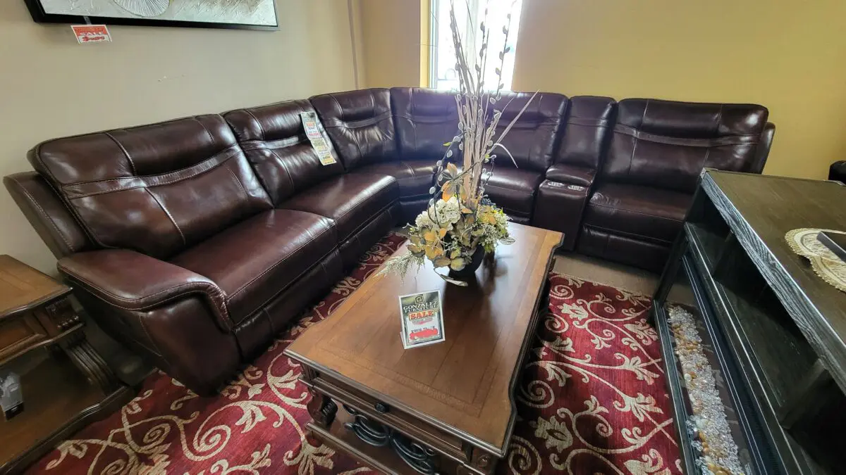 5169 Burgundy Sectional Living Room Set in top grain leather with modular pieces, manual recliners, and USB-equipped console, designed for comfort and versatility.