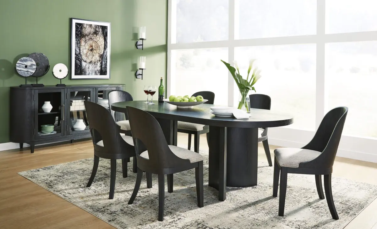 Rowanbeck 7 Piece Dining Room Set with oval table and six chairs, featuring black finish and herringbone fabric cushions in a modern dining room setting