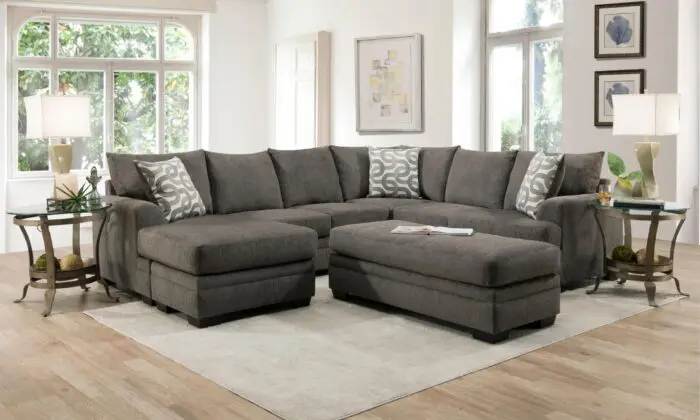 Bailey Charcoal 2 Piece Sectional with Chaise in a bright living room.