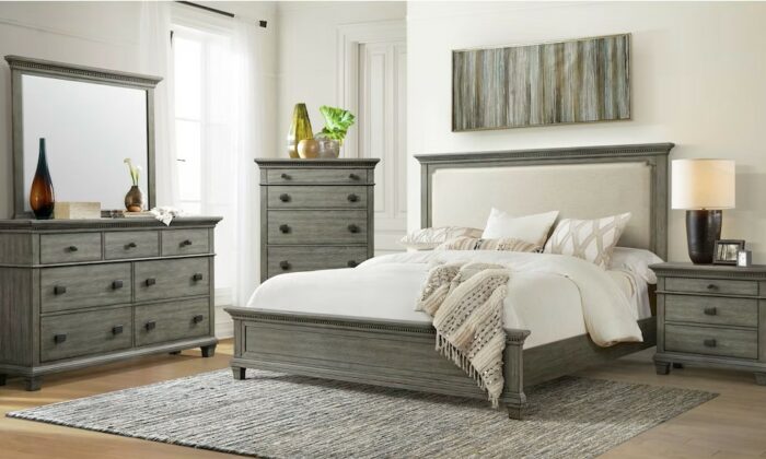 Grey bedroom set with panel bed, dresser with mirror, and nightstand. Solid pine and acacia wood frame with neutral upholstered headboard. Case pieces with black metal drawer pulls, ball bearing drawer glides, and felt-lined top drawers. Nightstand includes power plug and two USB ports for bedside charging. Low profile design with tapered legs, light grey finish, and engineered wood with veneer construction.