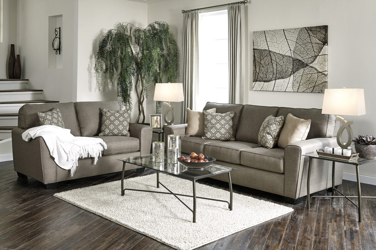 Calicho 2 Piece Living Room Set in Cashmere, featuring a sofa and loveseat with sleek woven upholstery, wide tapered arms, and brown and cream ikat pattern pillows