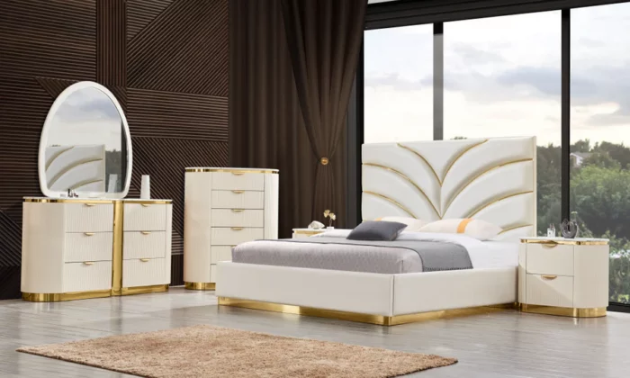 B1001 6 Piece Bedroom Set featuring crisp white upholstery with gold trim, geometric headboard design, ribbed nightstand and dresser textures with gold hardware, and an oval mirror.