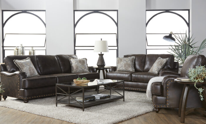 Ridgeline Brownie 2 Piece Living Room Set, featuring a plush sofa and loveseat upholstered in dark brown fabric with nailhead trim and ornately carved wooden feet.